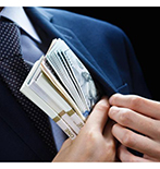 Fraud Man putting money in suit jacket
